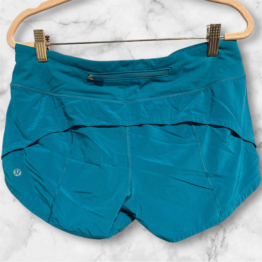 TEAL LULULEMON SHORTS, 6 T